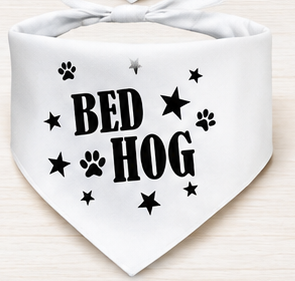 White bandana with 'BED HOG' text and paw prints on a light wooden surface